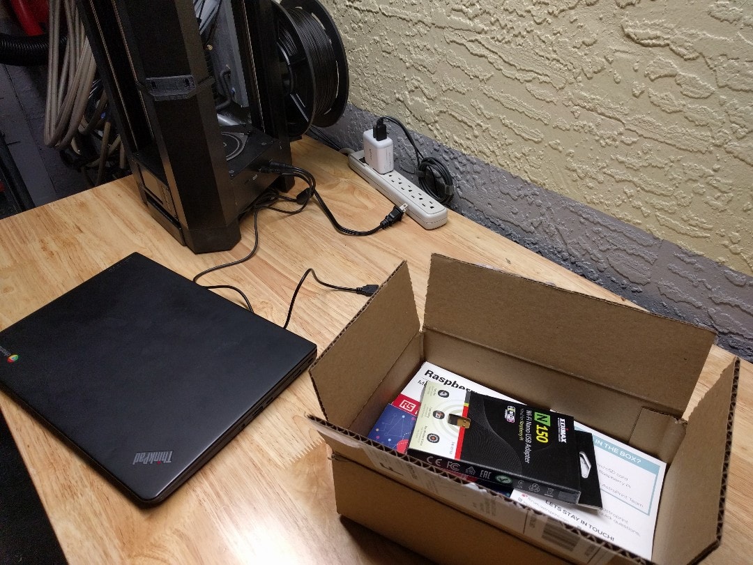 A printer, a chromebook, and a box of AstroPrint parts